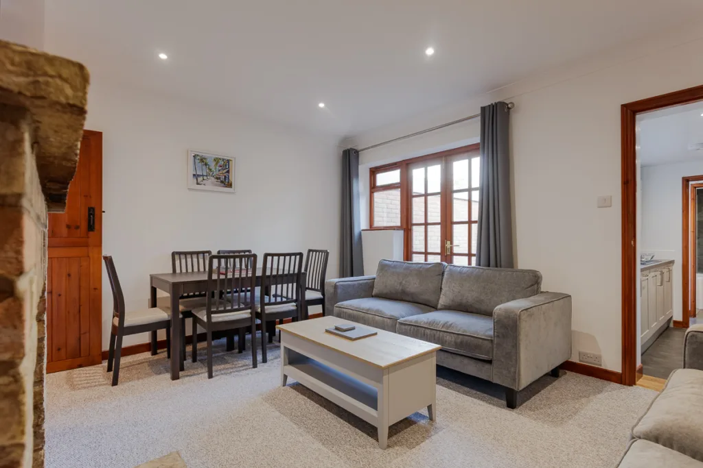 Modern living room with dining area and sofa.