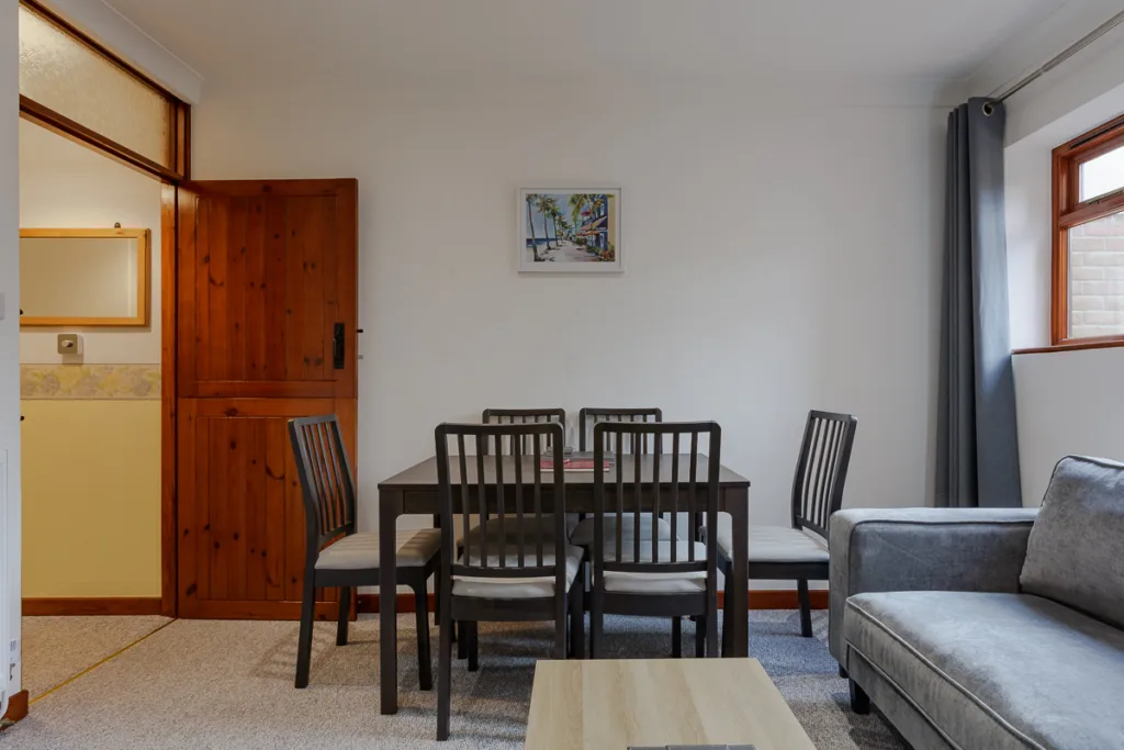 Modern dining room with table and chairs.