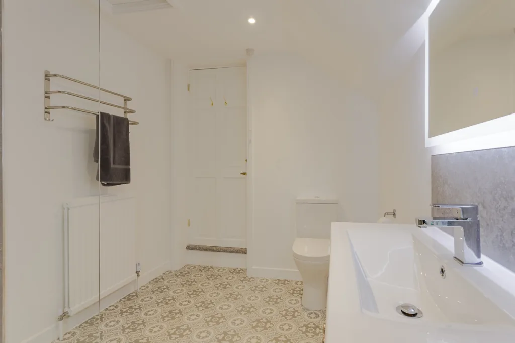 Modern bathroom with patterned floor tiles.