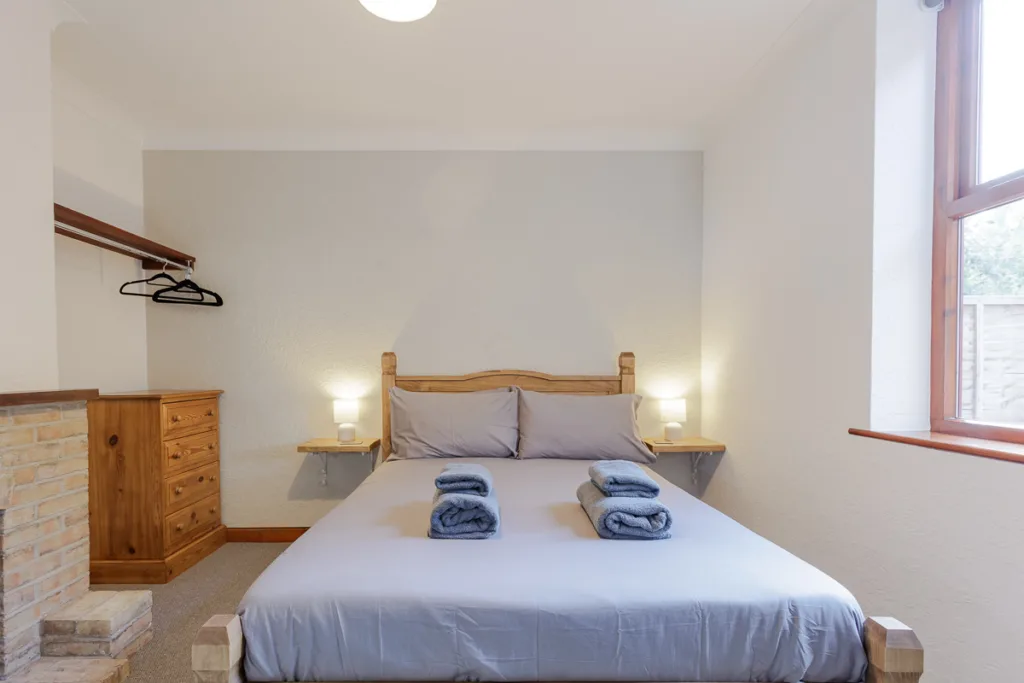 Cosy bedroom with double bed and soft lighting.