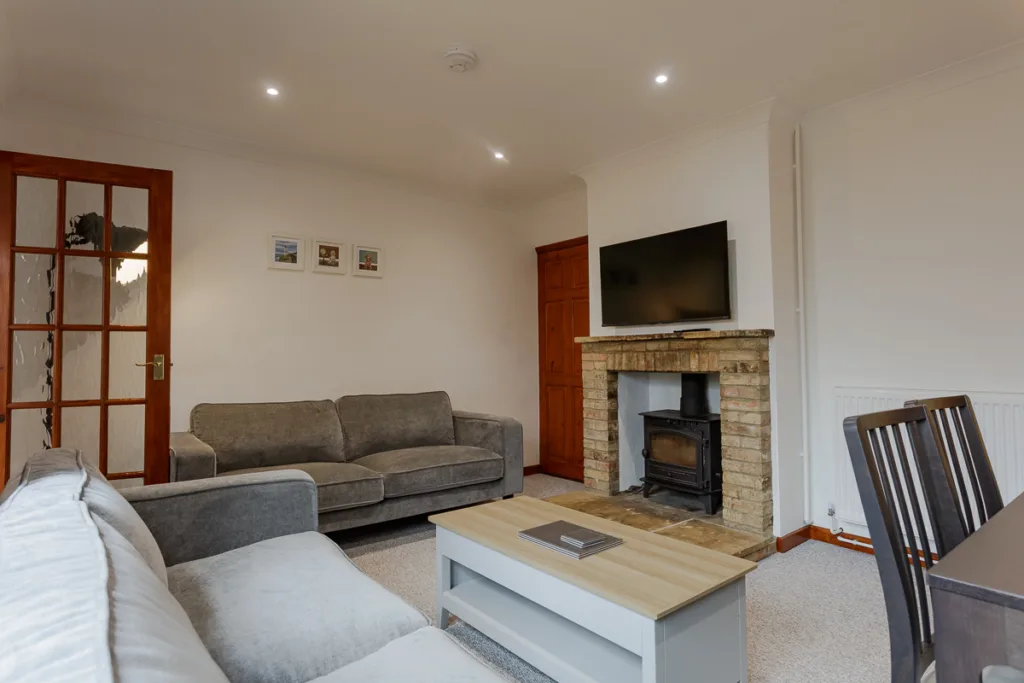 Cosy living room with fireplace and modern furniture.