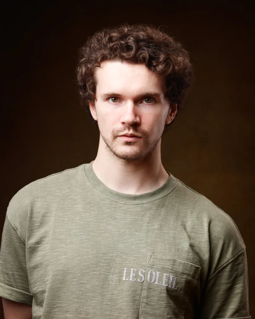 Person in green shirt with 'Le Soleil' text.