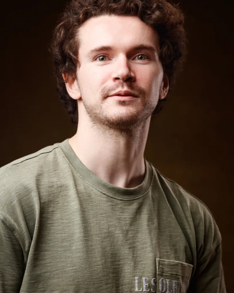 Man in green shirt, brown background