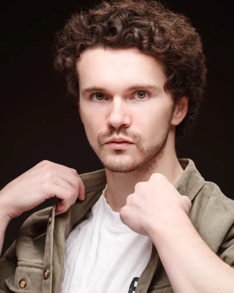 Man posing with open green jacket
