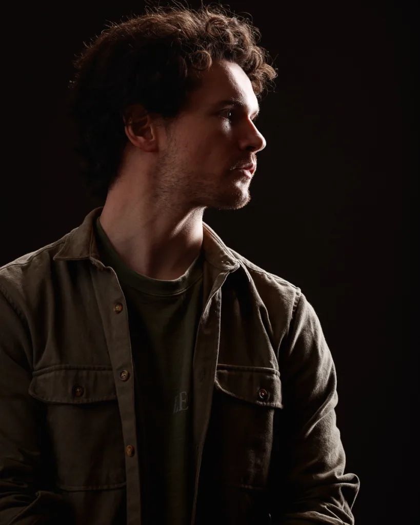 Moody portrait of man in dramatic lighting.