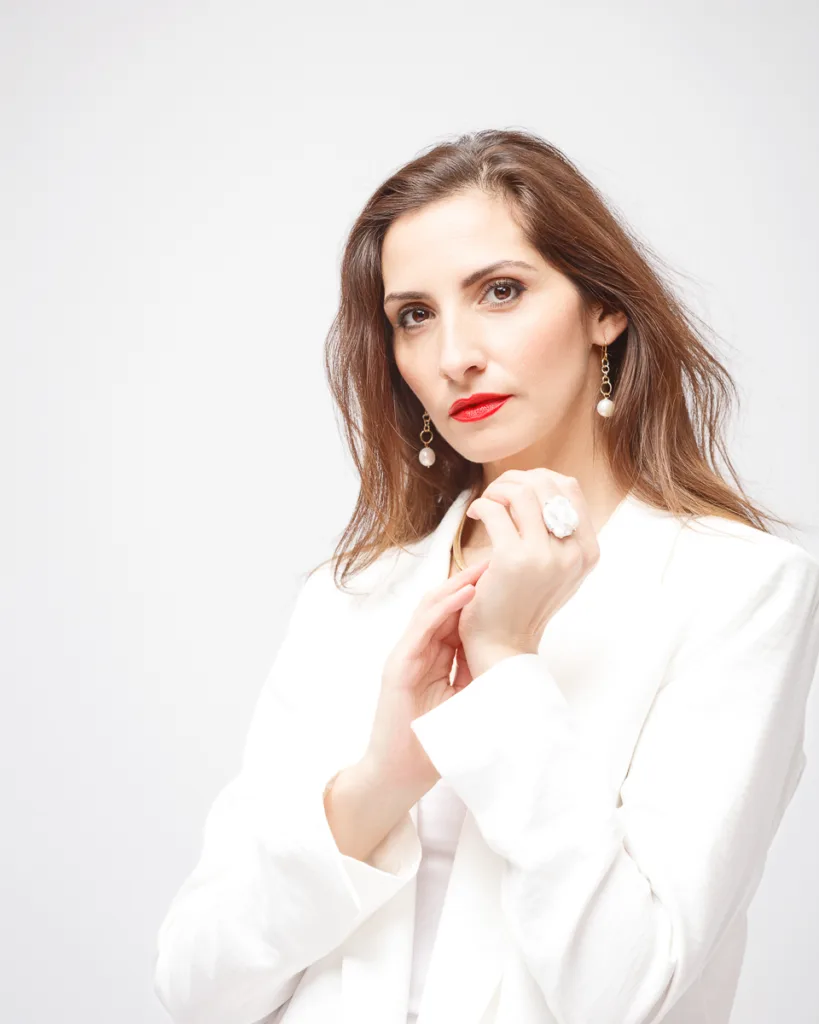 Woman in white blazer with elegant jewellery