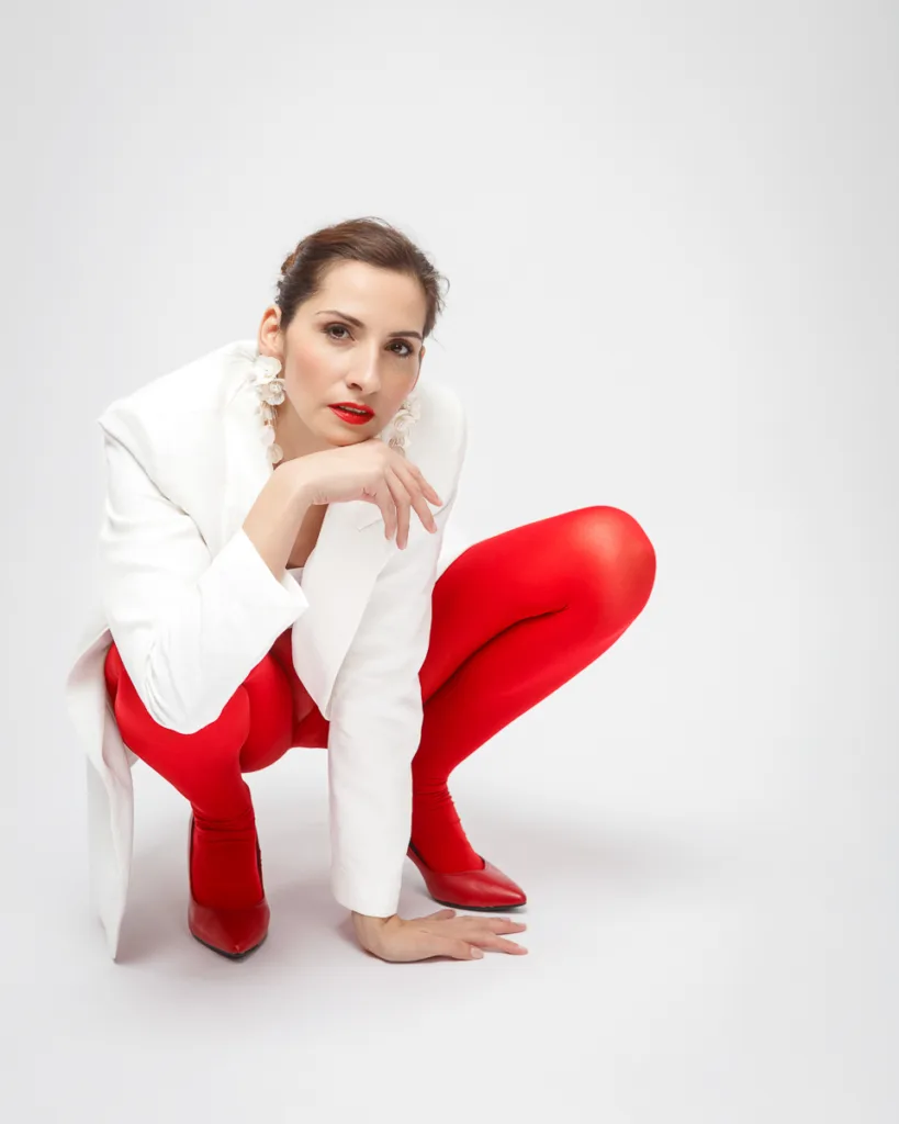 Fashionable woman in white coat, red tights