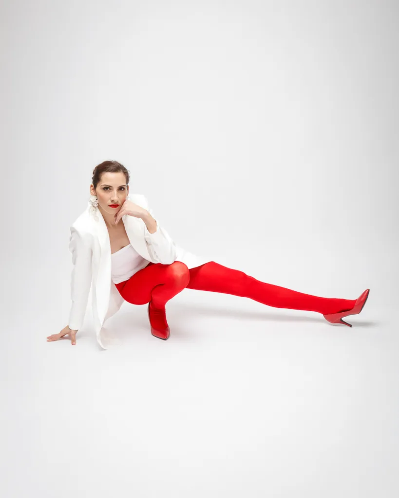 Woman posing in white jacket and red tights