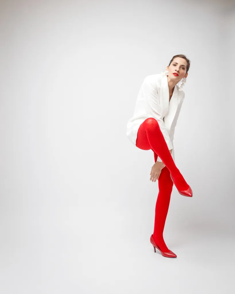 Woman in red stockings adjusting pose.