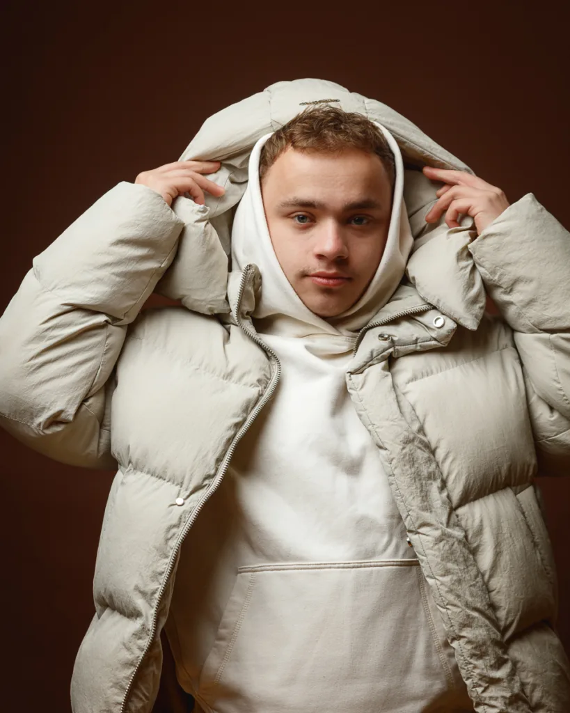 Person wearing white puffer jacket and hoodie.