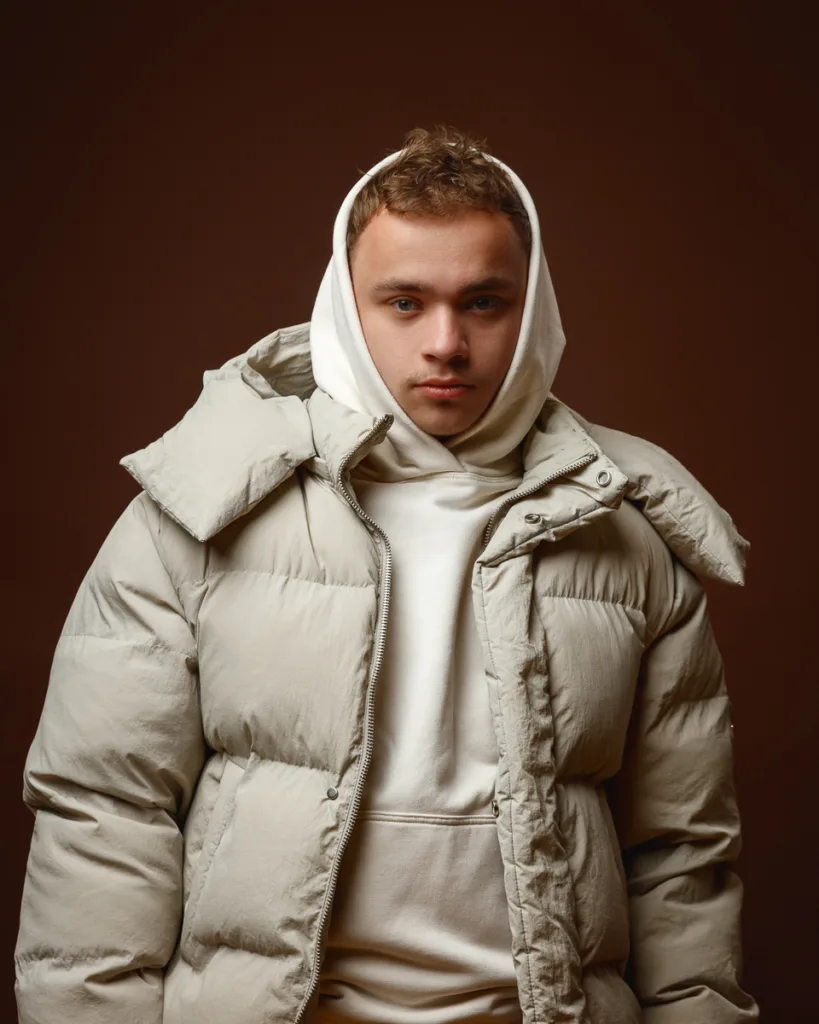 Person in beige puffer jacket with hood.