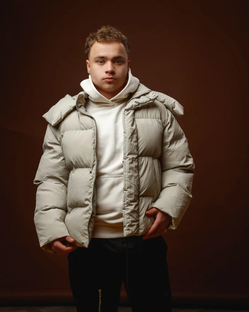 Person in beige puffer jacket and hoodie.