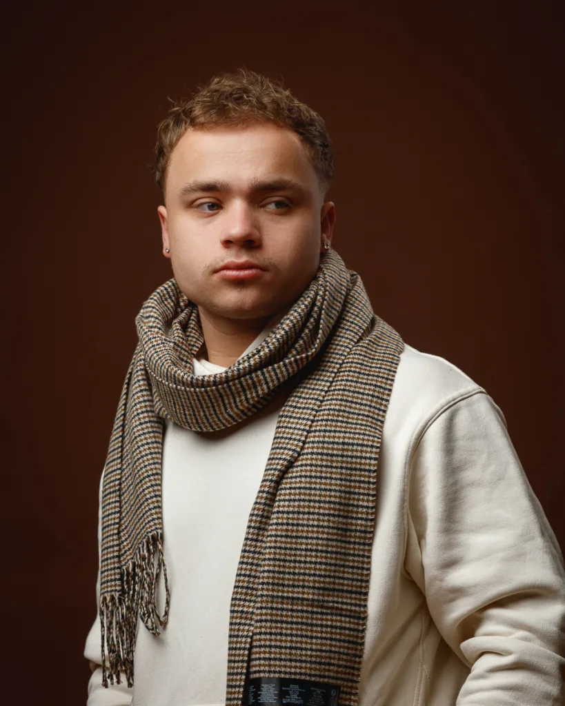 Person wearing a scarf and looking to the side.