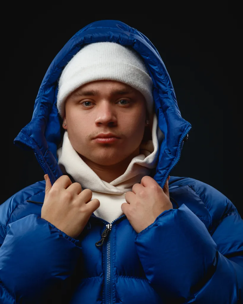 Person in blue jacket and white beanie