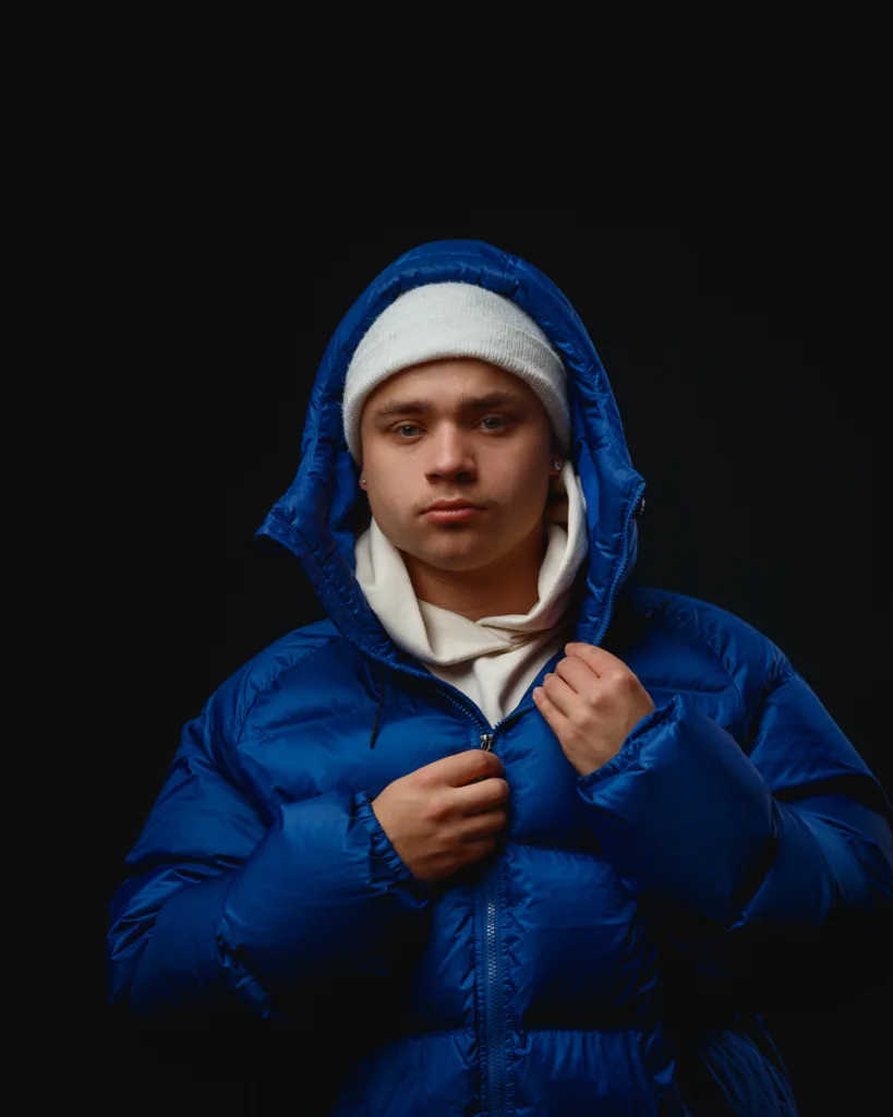 Person in blue puffer jacket with hood up.