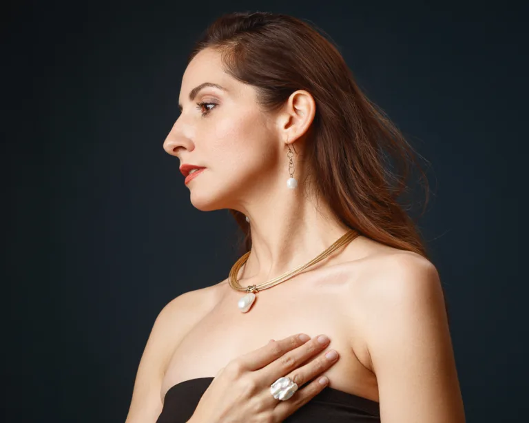 Woman wearing elegant jewellery, dark background