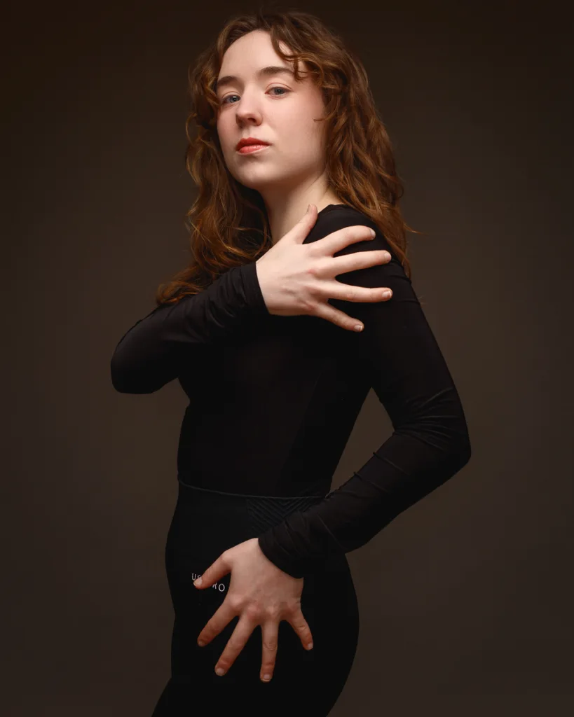 Woman posing confidently in black outfit