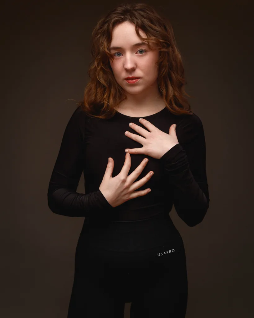 Person posing in black long-sleeve outfit