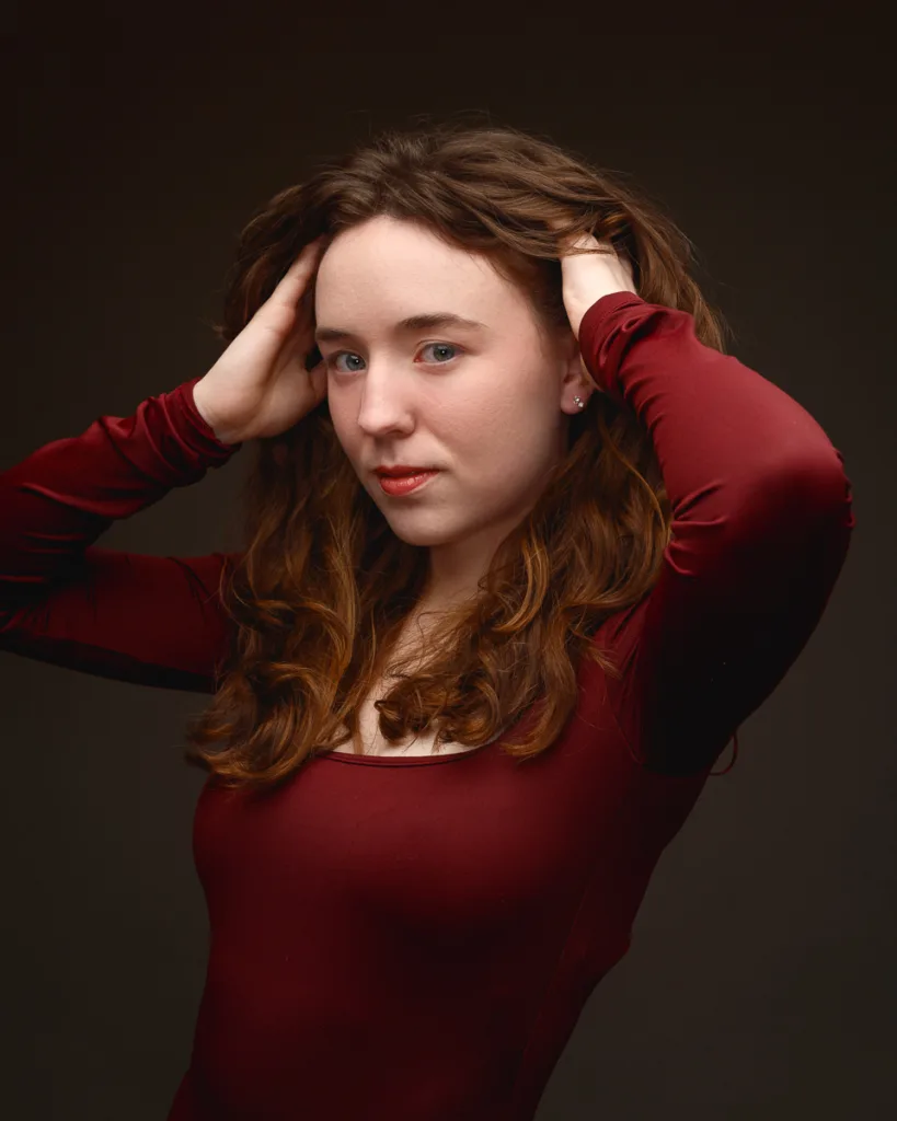Woman posing in red long-sleeve top