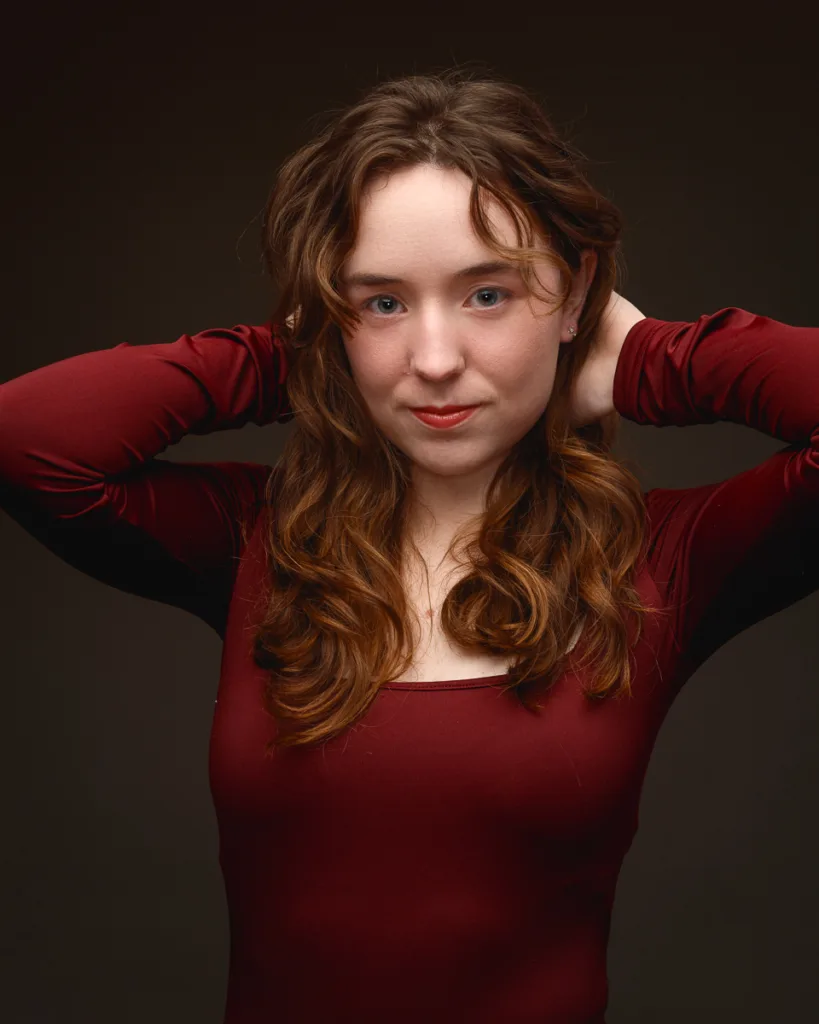 Woman posing with hands behind head