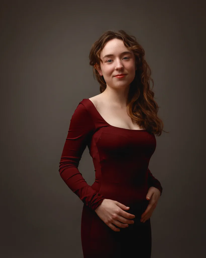 Woman posing in a burgundy dress