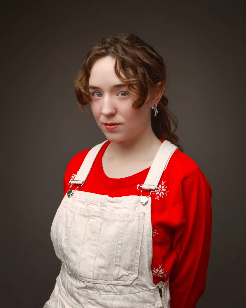 Person wearing red jumper and white overalls