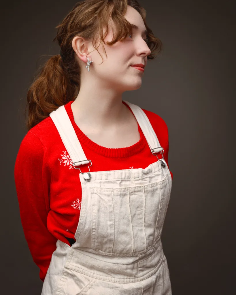 Person wearing red jumper and cream overalls