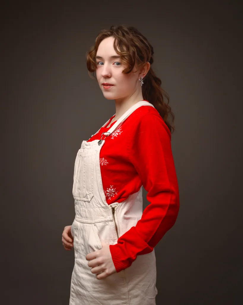 Person wearing red jumper and cream overalls