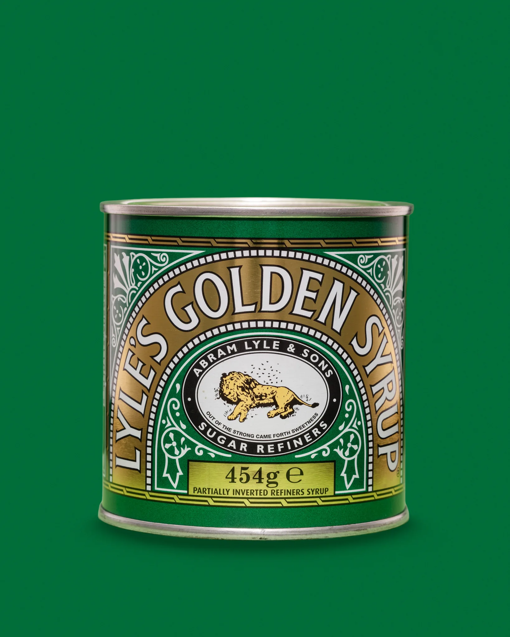 Lyle's Golden Syrup 454g tin on green background