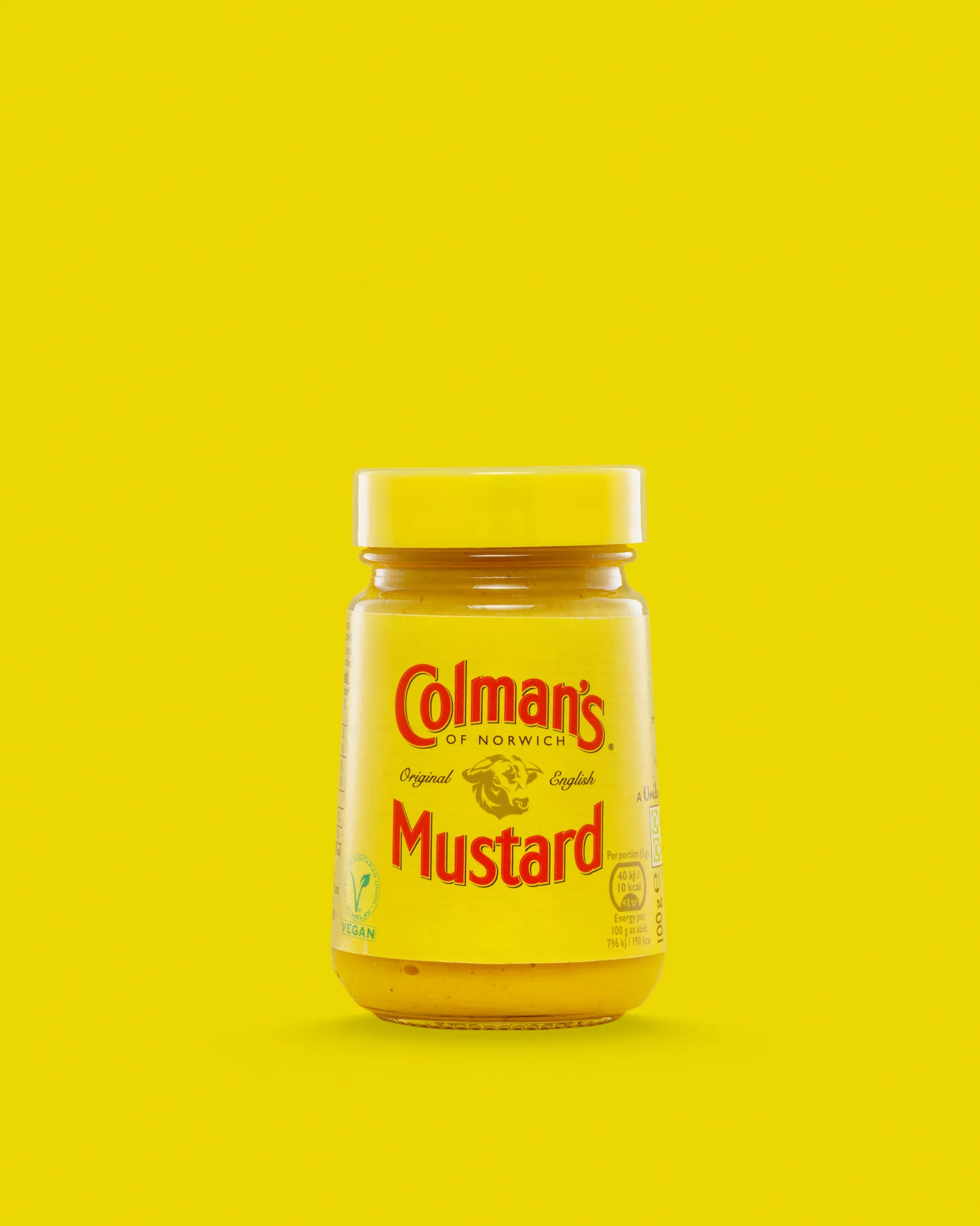 Jar of Colman's English mustard on yellow background