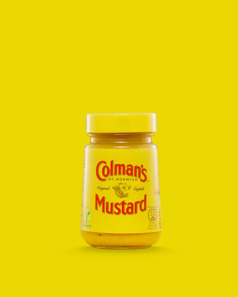 Product photograph of a jar of Colman's mustard on a yellow background