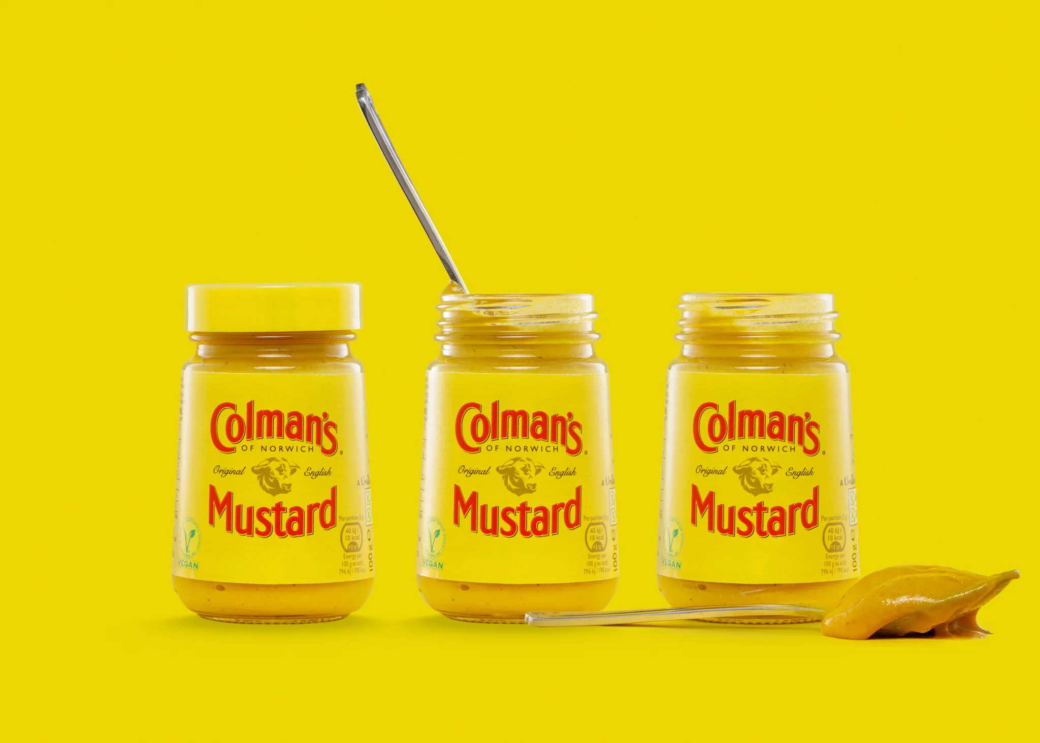 Three jars of Colman's English mustard with spoons