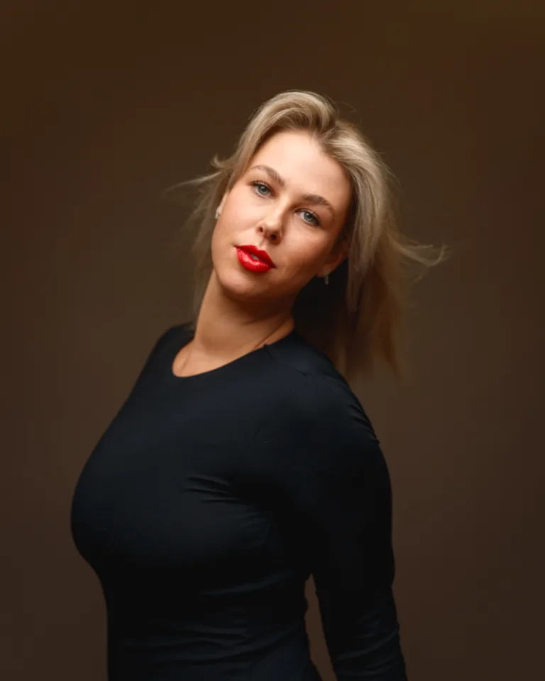 Person posing confidently in black dress