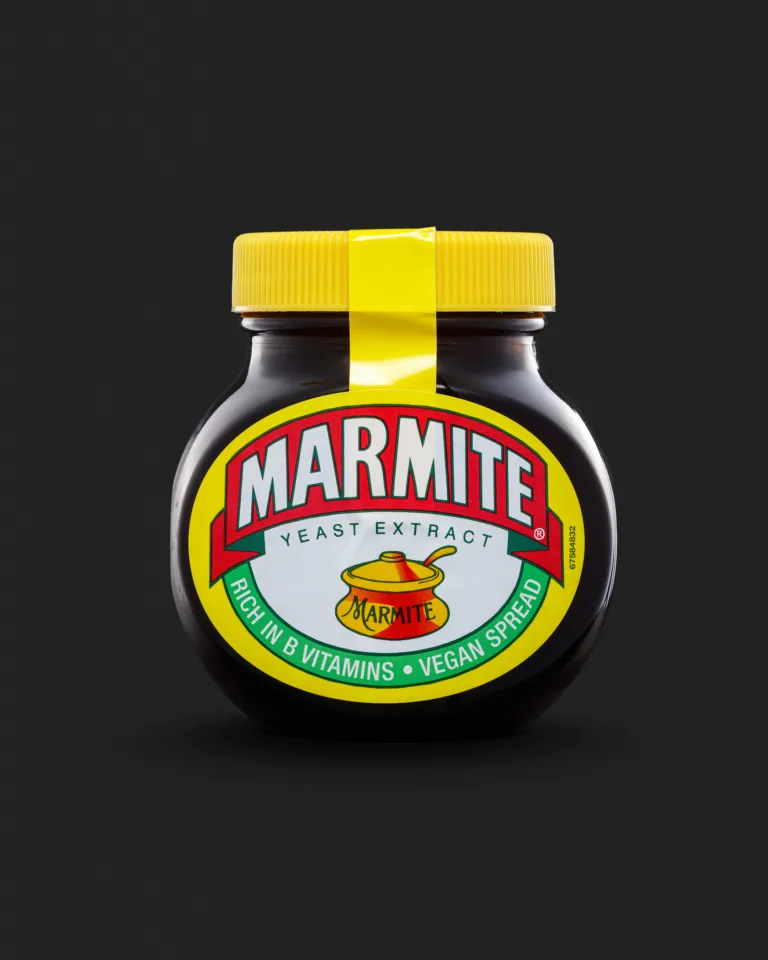 Product photograph of a jar of Marmite on a black background