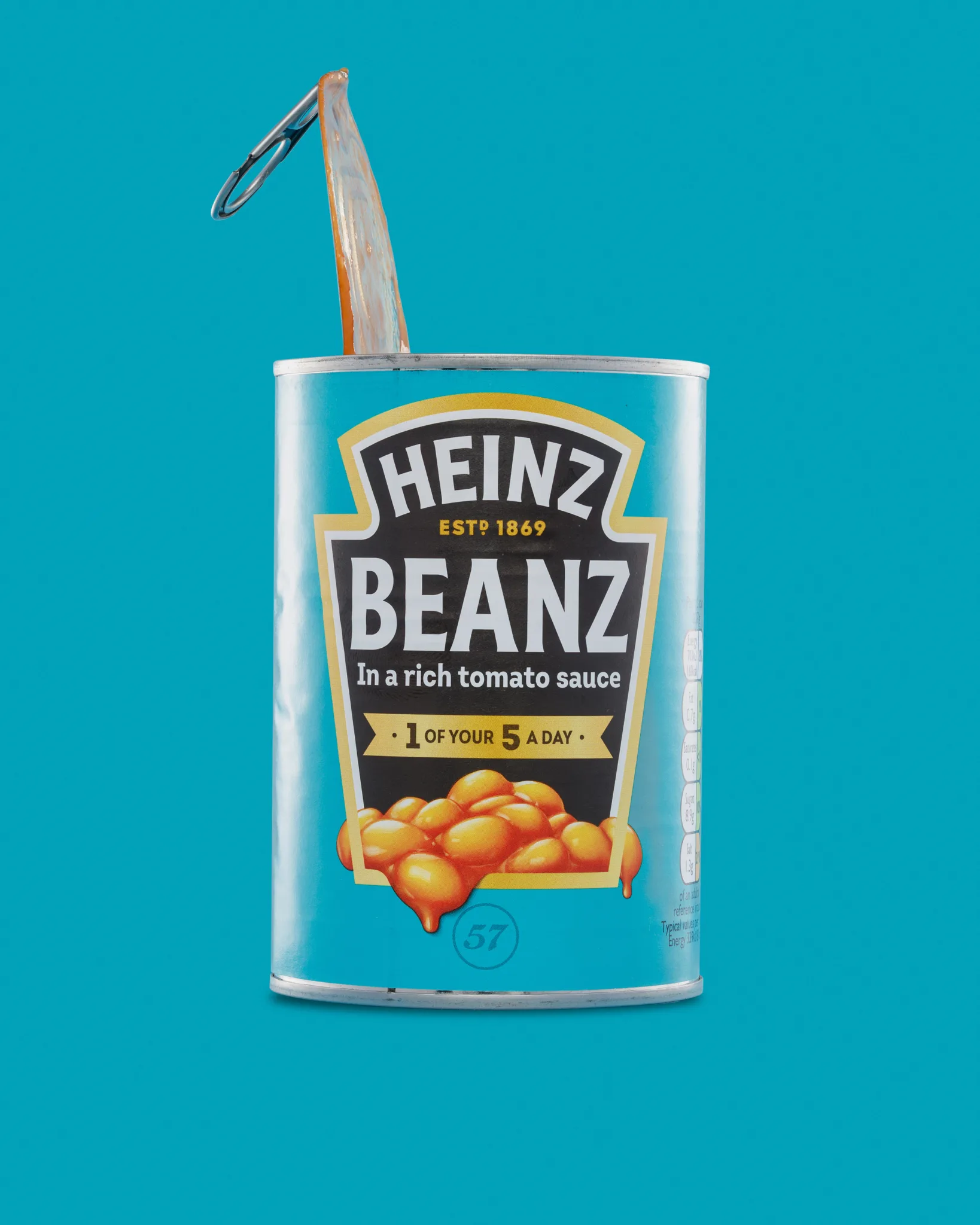 Opened tin of Heinz baked beans on blue background