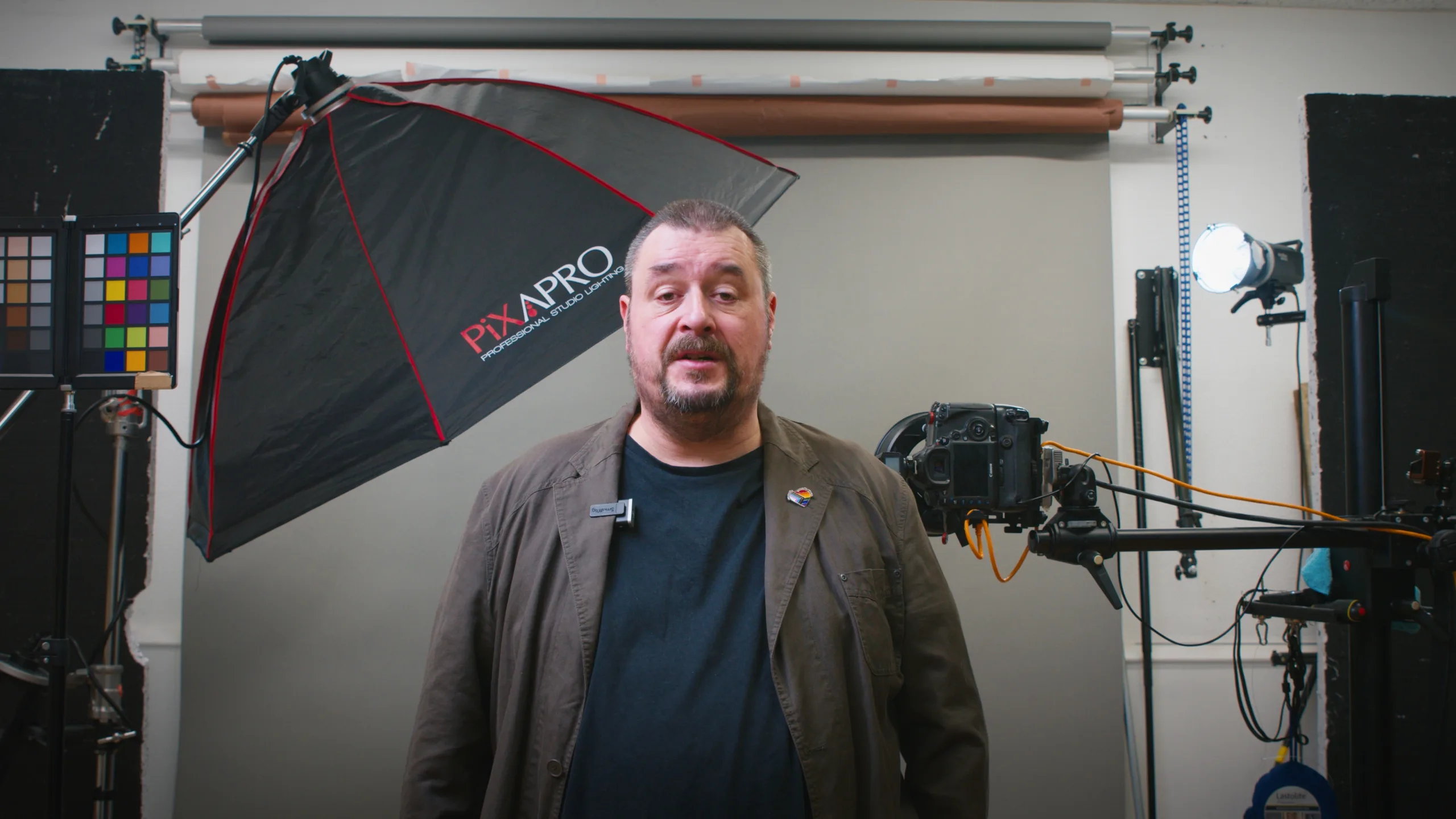 Man standing in photography studio with lighting equipment