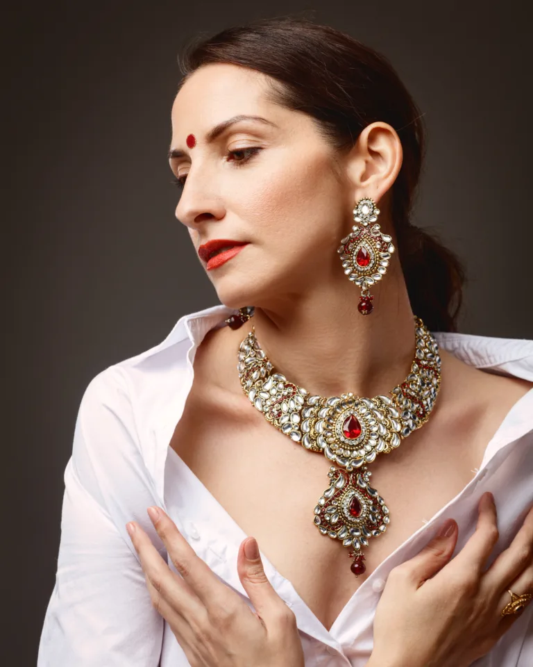 Woman wearing ornate gold and red jewellery