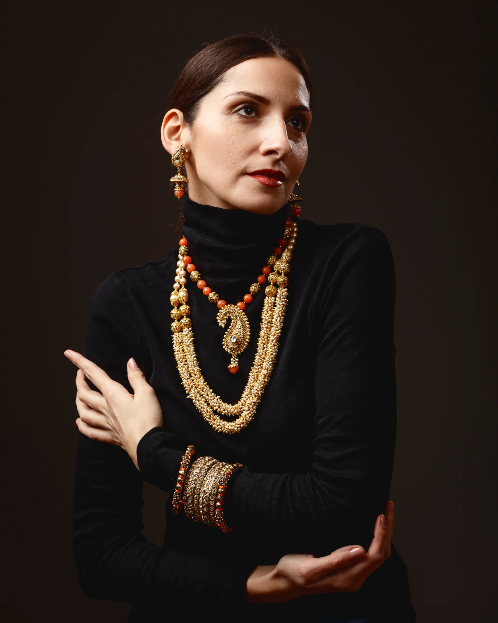 Woman wearing ornate gold jewellery set