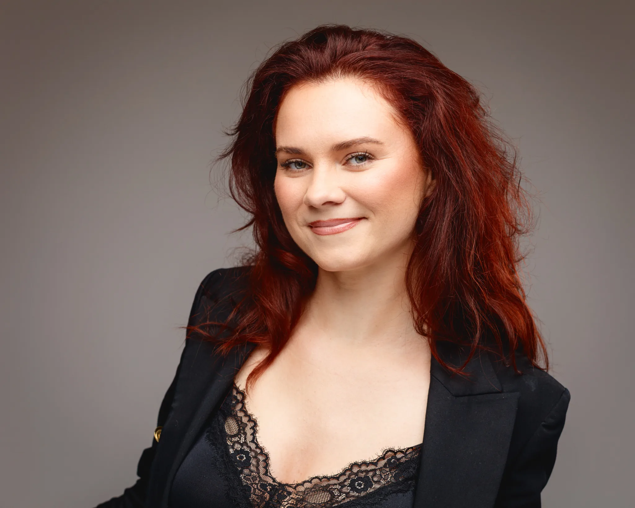 Woman with red hair in black lace outfit