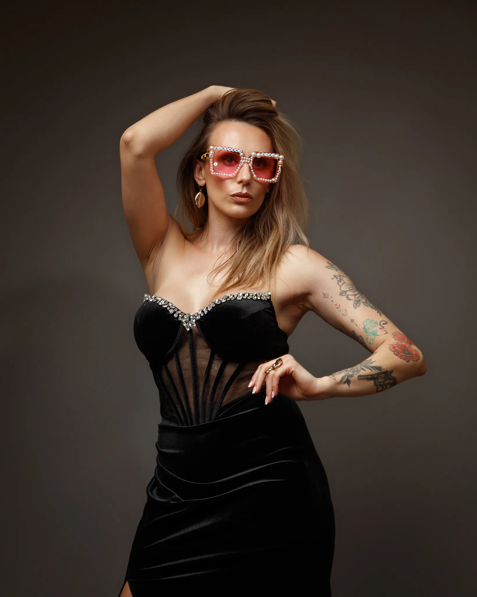 Woman in elegant black dress, pink sunglasses