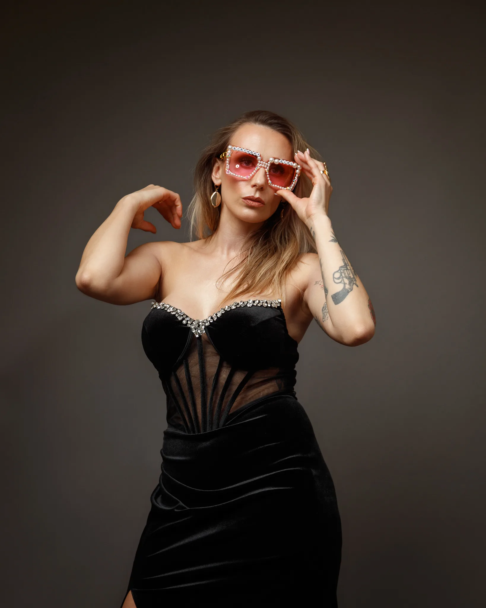 Woman in elegant black dress and sunglasses