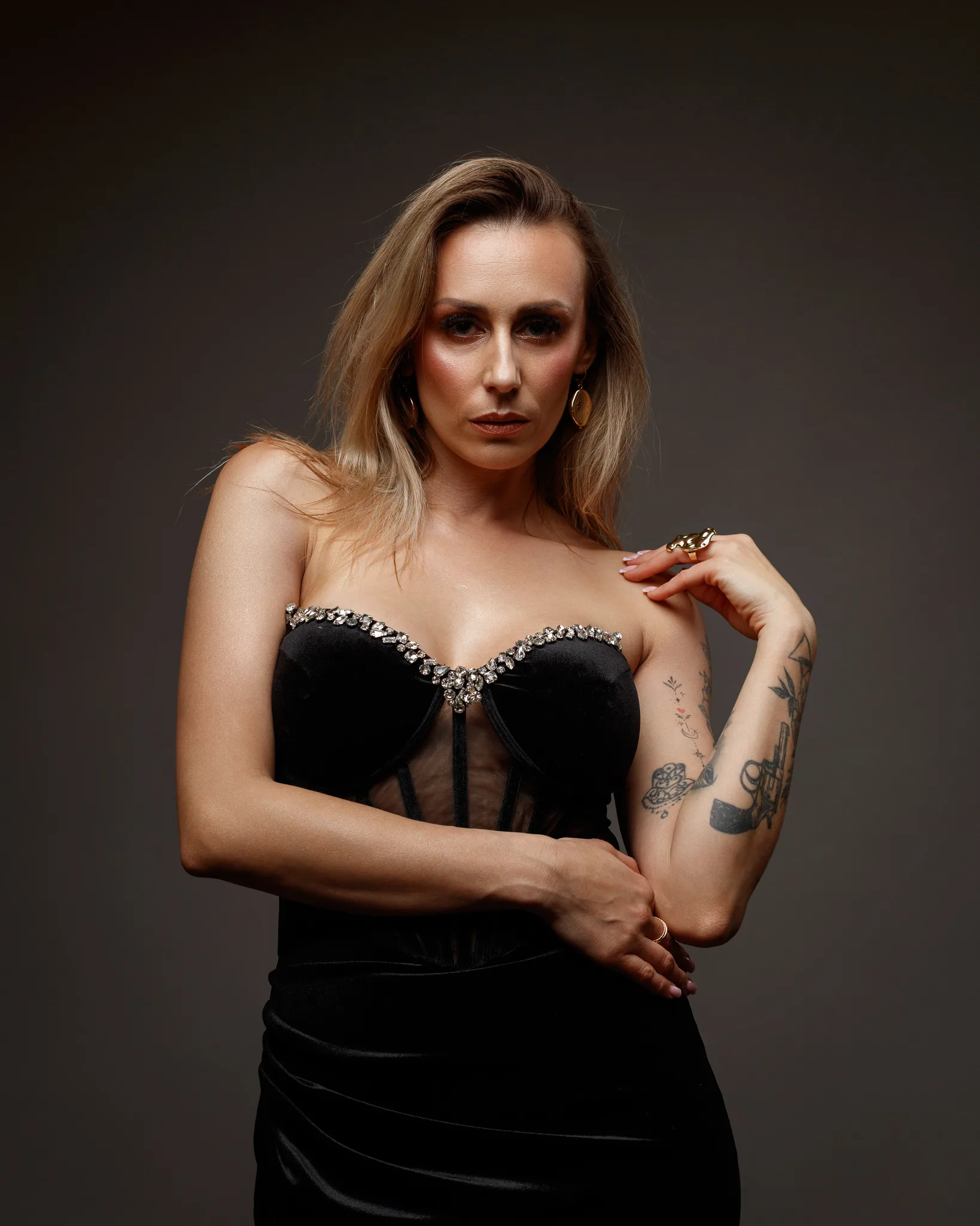 Woman in elegant black dress posing confidently