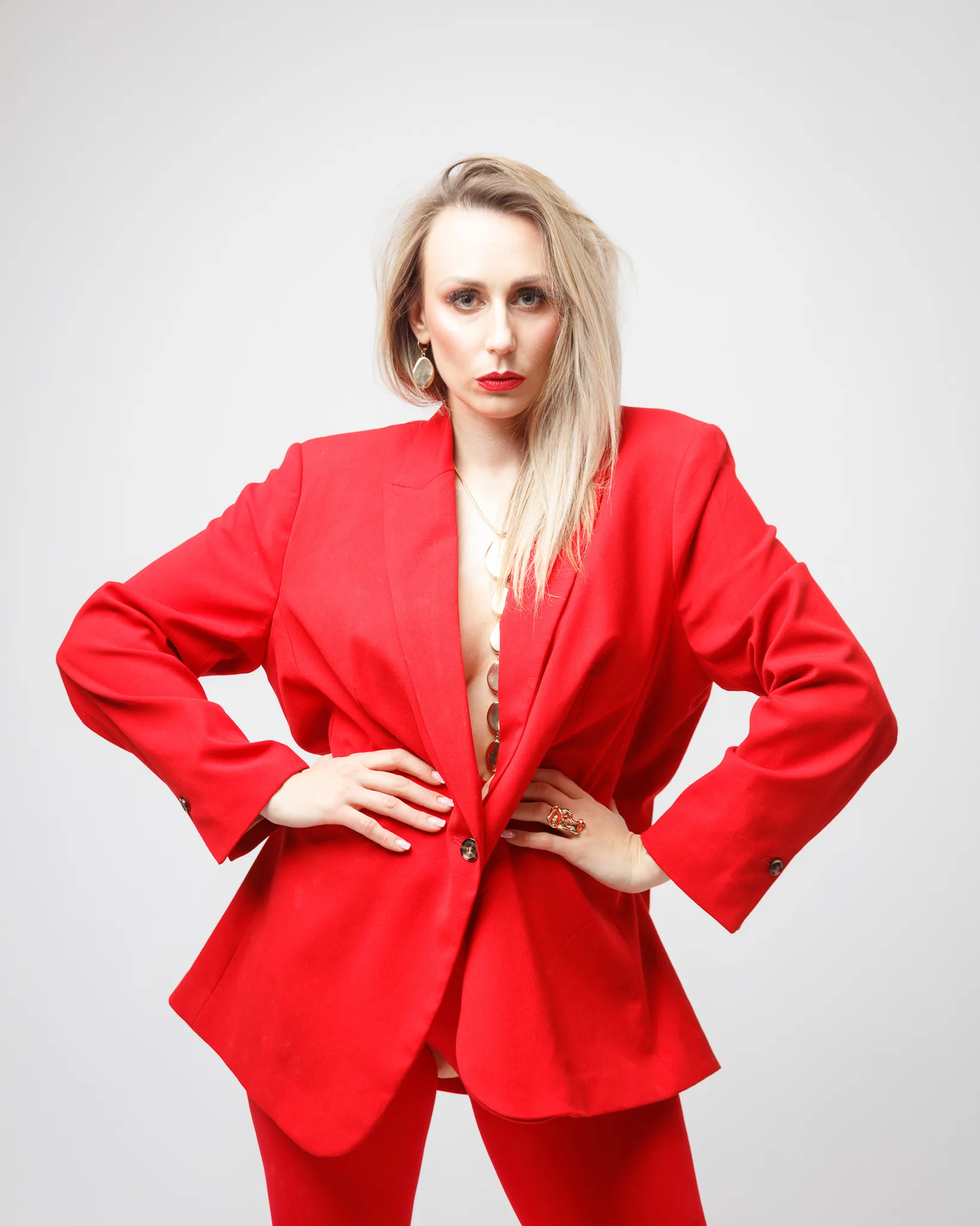 Person wearing striking red suit posing confidently.