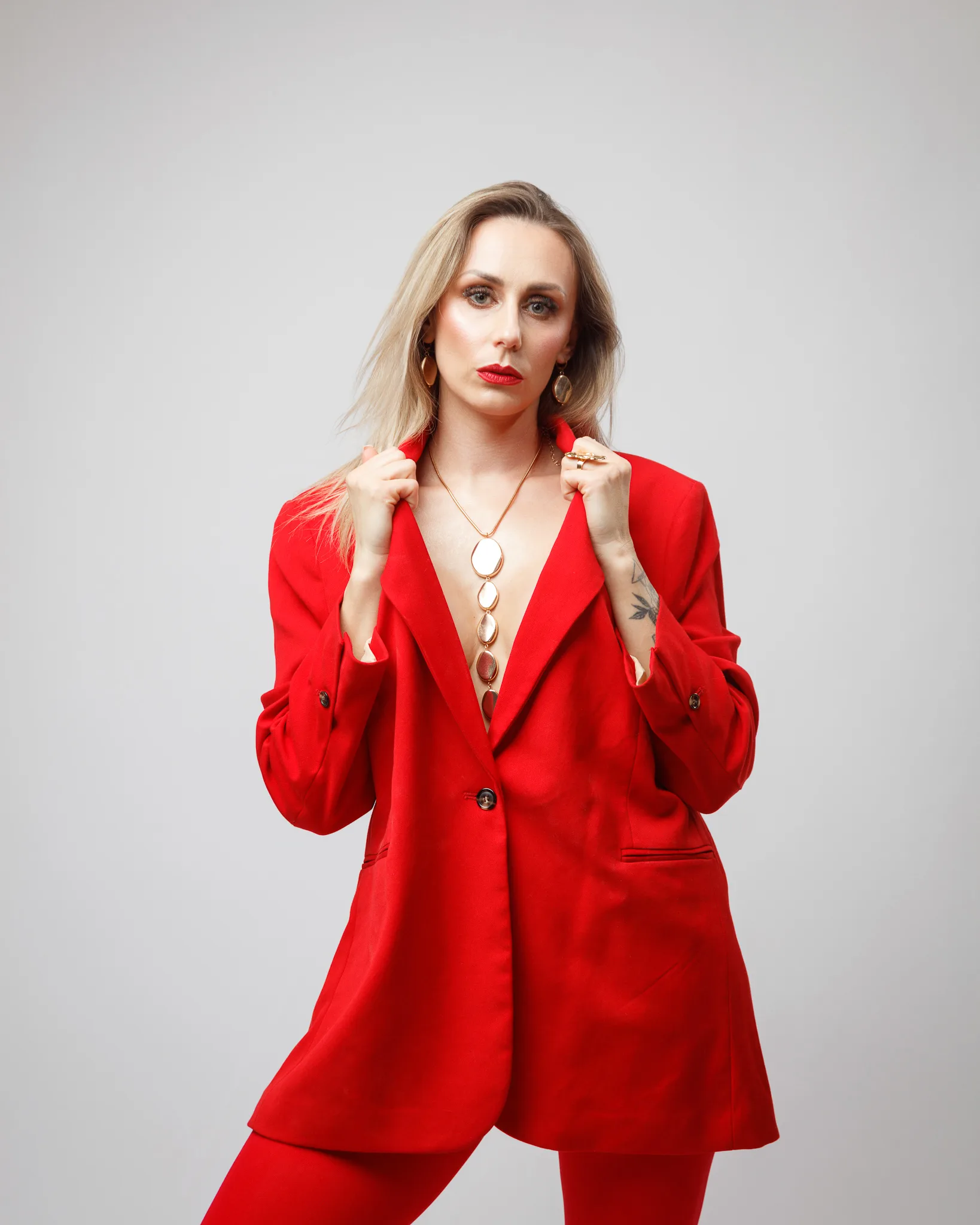 Person in red suit posing confidently