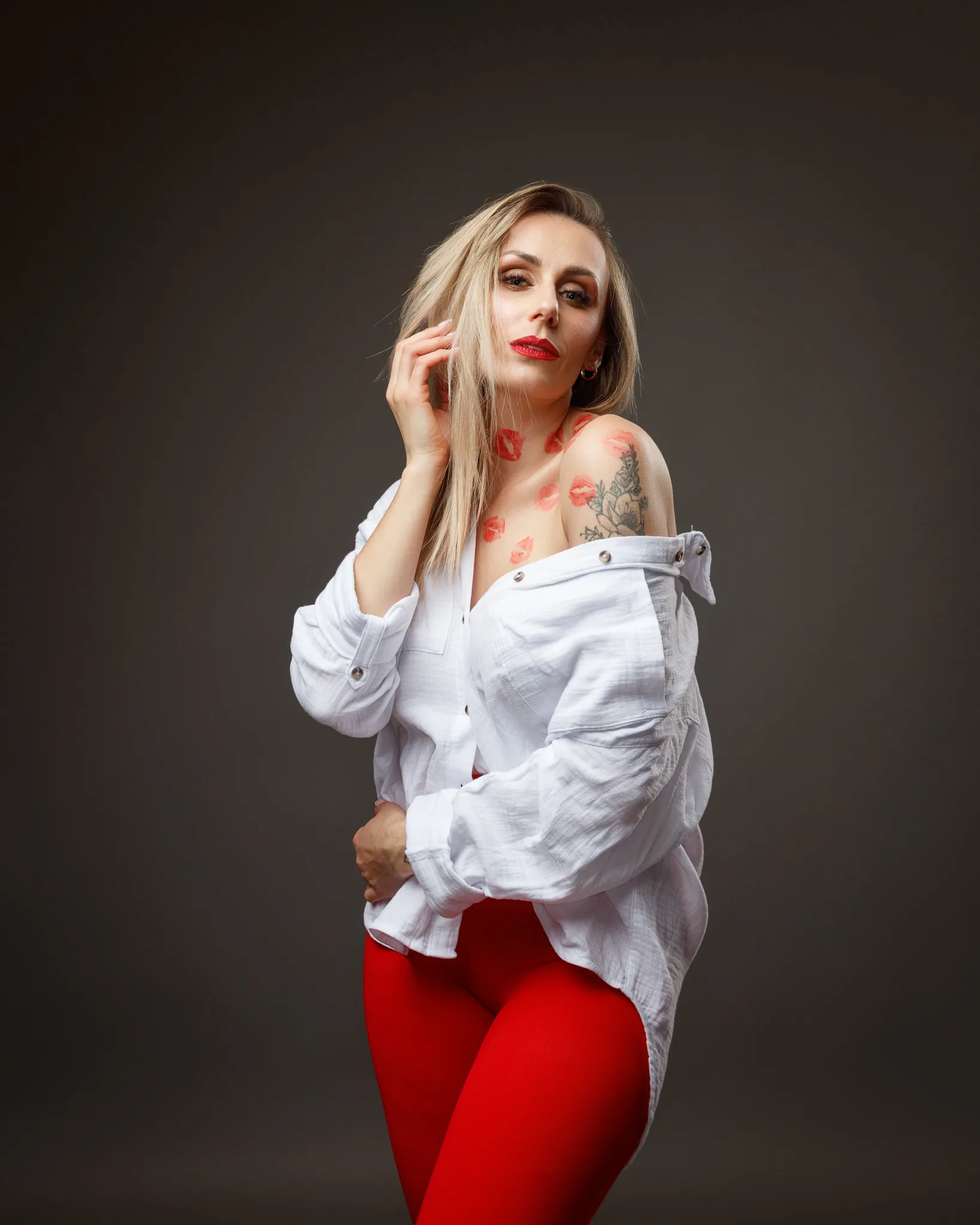 Woman in red trousers and white blouse posing