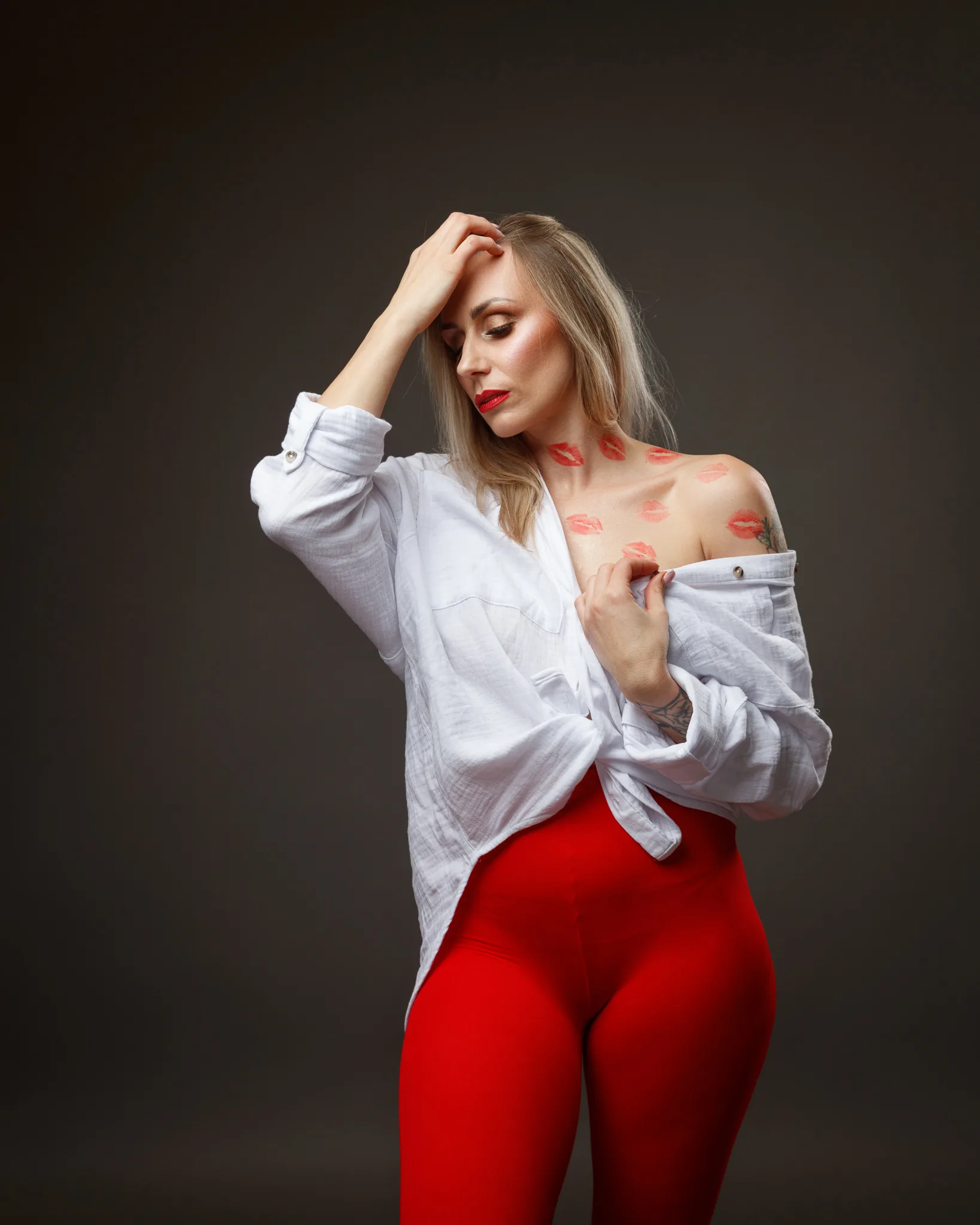 Woman in red leggings with kiss marks on skin.