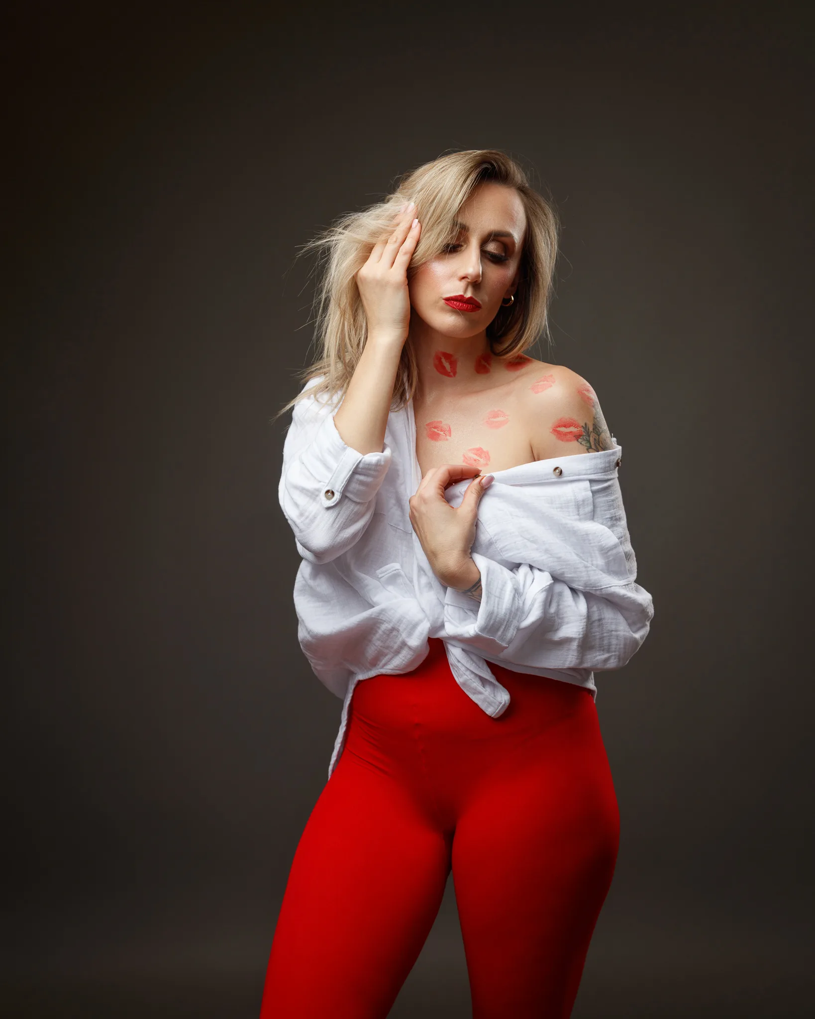Woman in white shirt, red lipstick marks