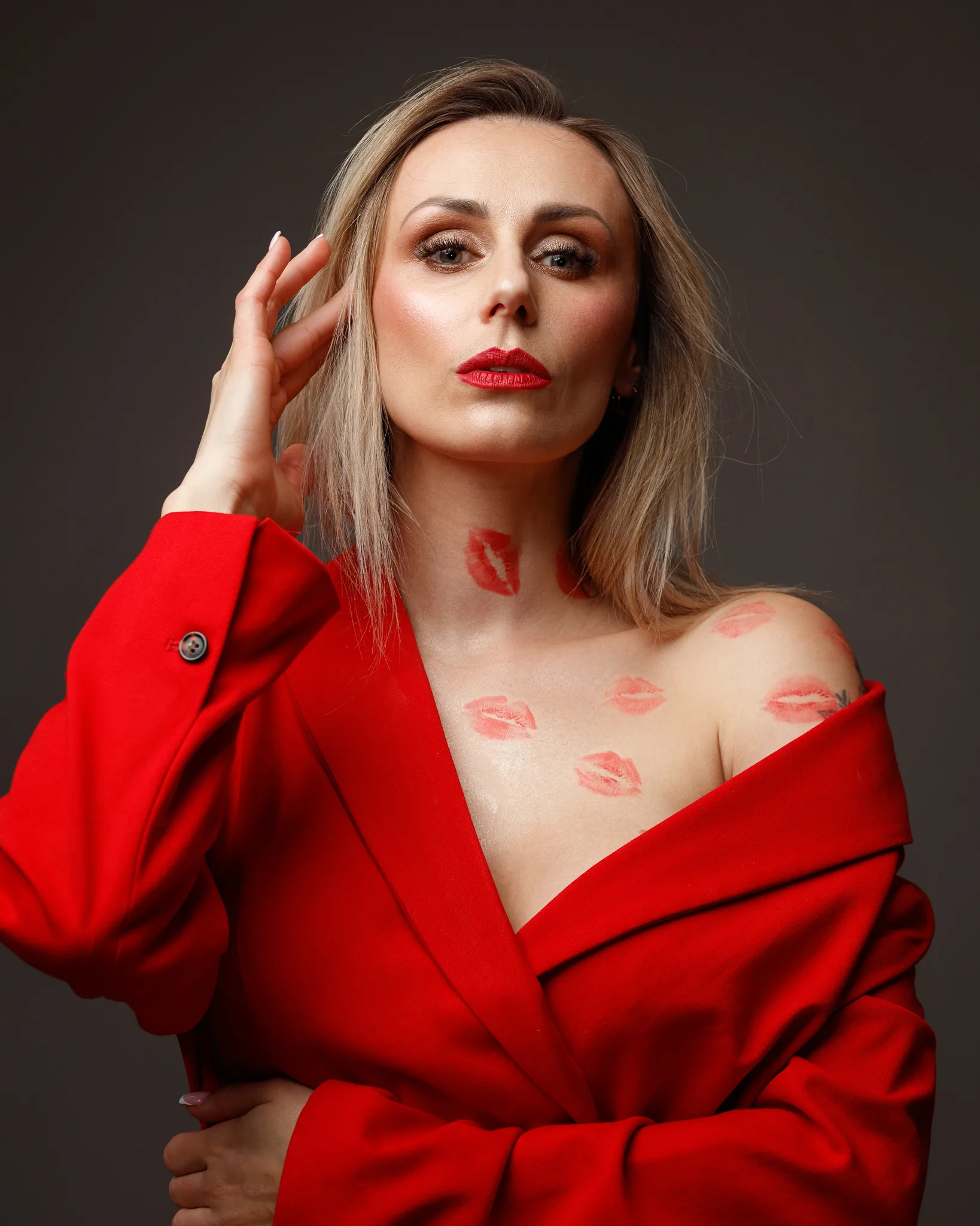 Woman in red coat with lipstick marks