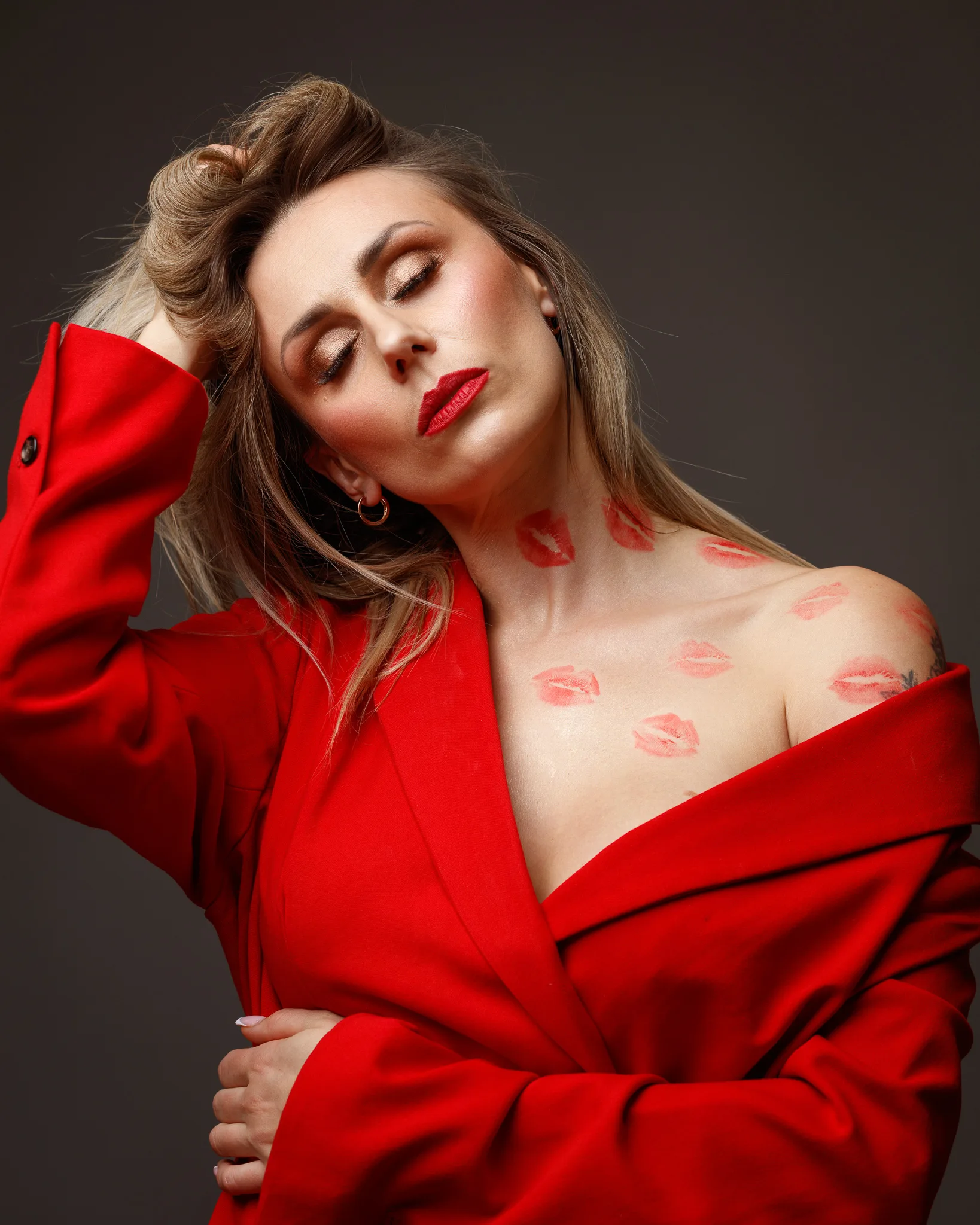 Woman in red jacket with lipstick marks.