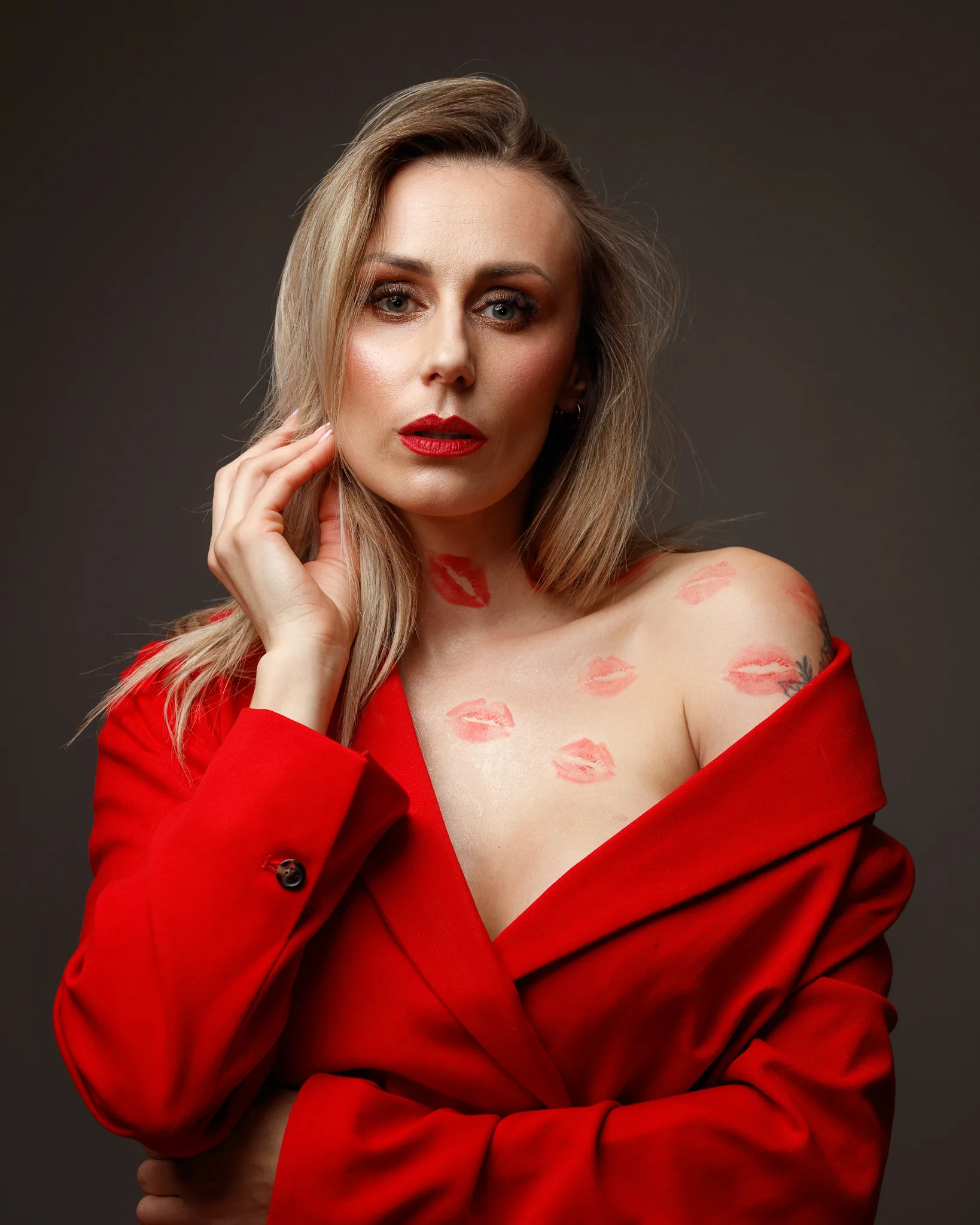 Woman in red coat with lipstick marks.